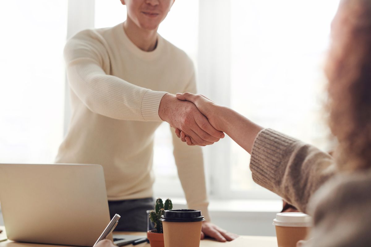 Two businesspeople having a friendly meeting over coffee