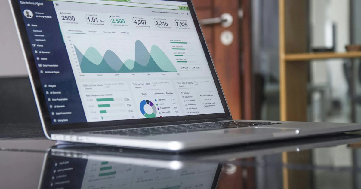 Business owner reviewing marketing analytics on a laptop