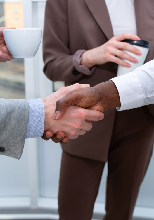 Two professionals shaking hands during a friendly business meeting