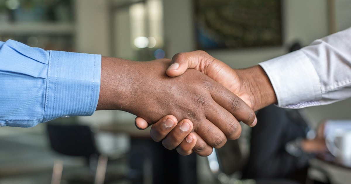 Two people shaking hands after agreeing to work together
