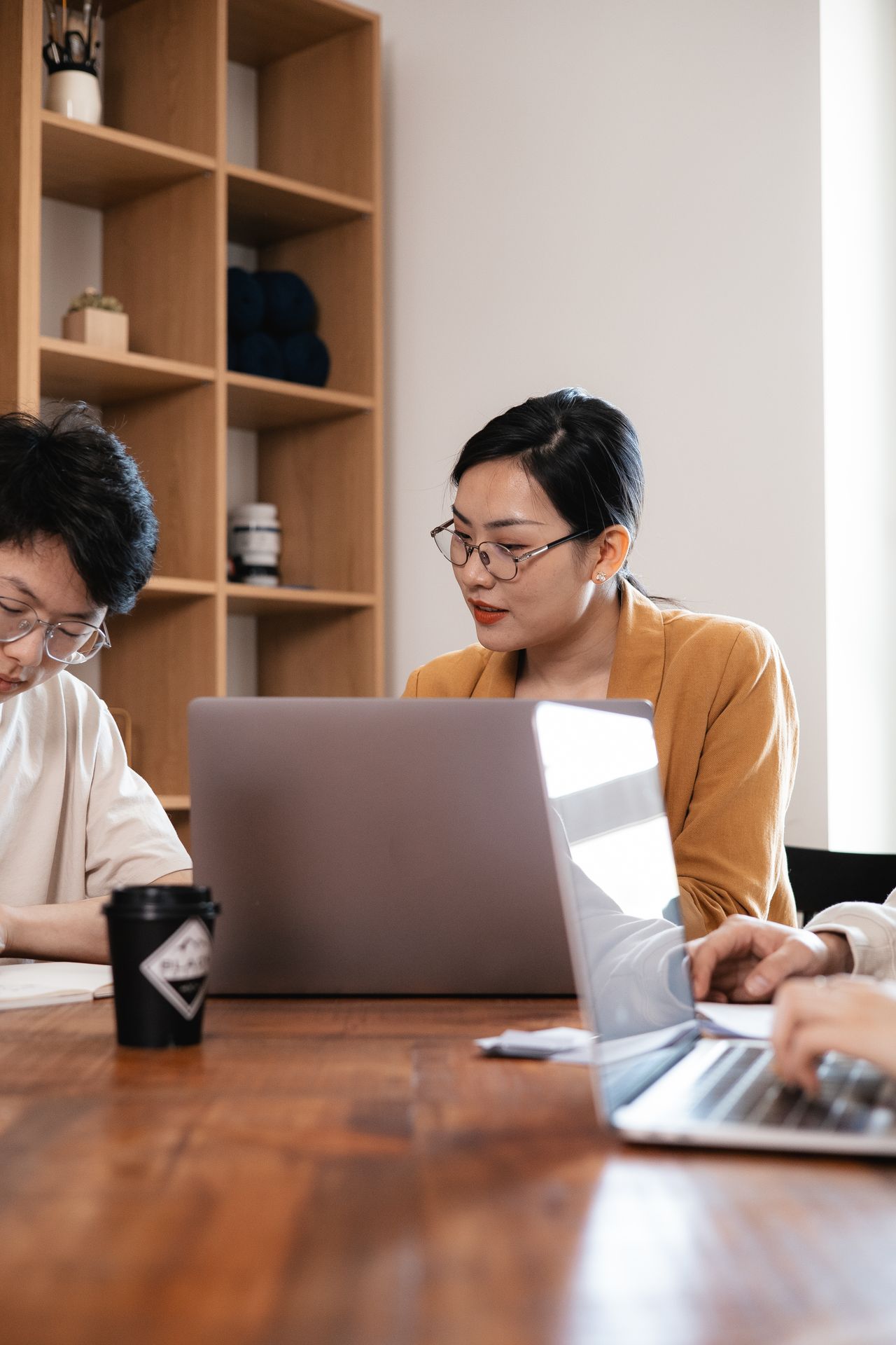 Two colleagues working together on business software using a laptop