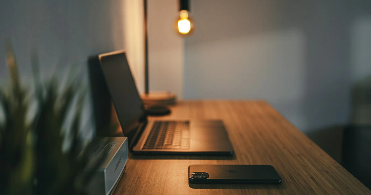 Small business owner reviewing a website design on a laptop at a tidy desk