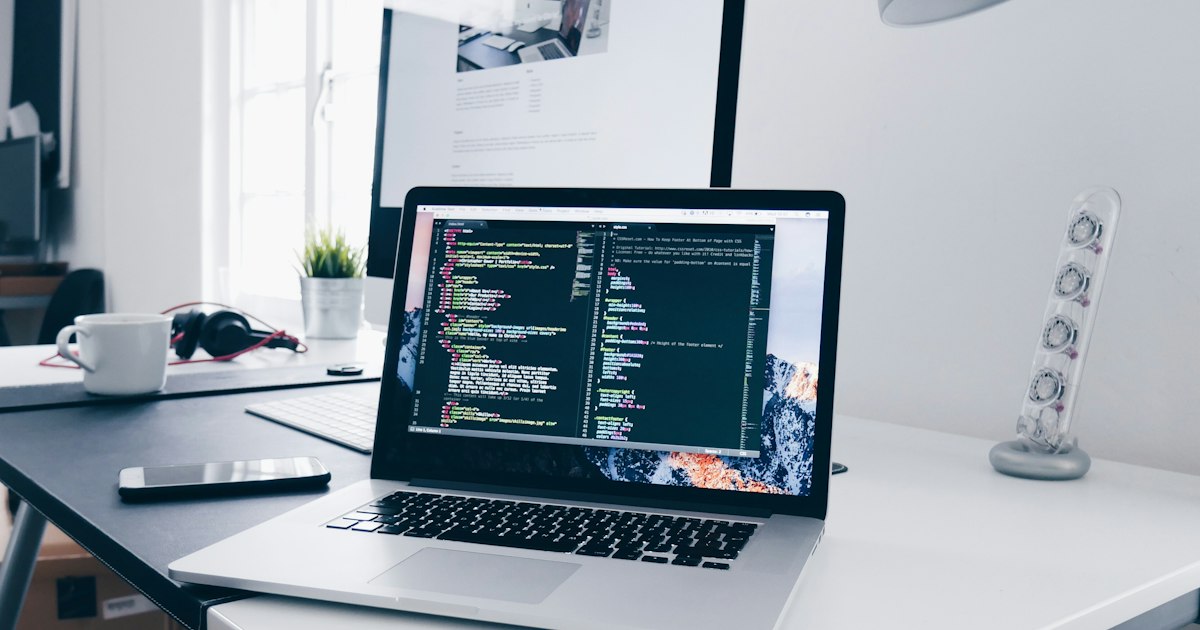 Person working on website development on a laptop at a desk